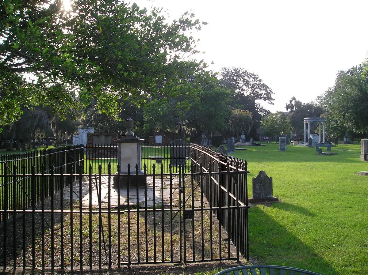 Iron-fenced family plots and headstones under oaks in Colonial Park Cemetery, Savannah, a stop for ghost tours in Savannah GA